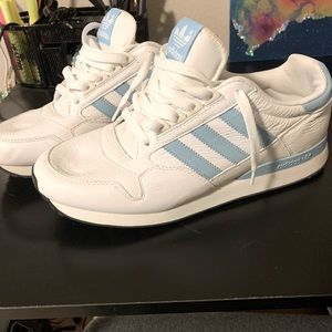 Still brand new white and Carolina blue adidas. Size 9.5